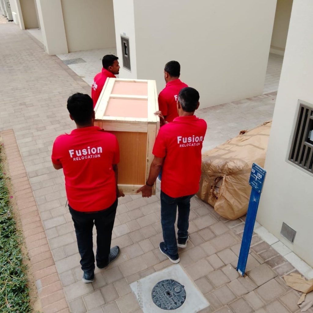 Fusion crew delivering a wooden crate to a villa doorstep