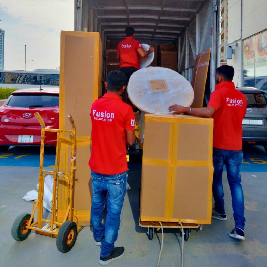 Fusion crew unloading wrapped furniture from a truck on delivery day